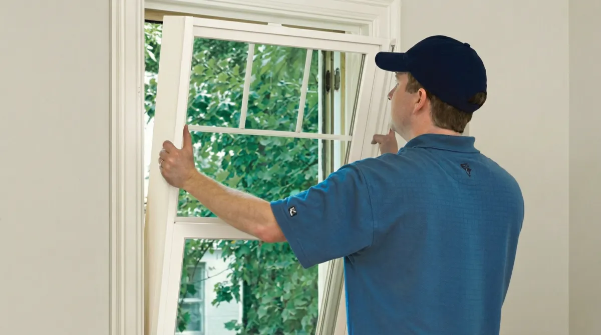 Professional contractors performing a residential window insulation and replacement service in Evansville, IN
